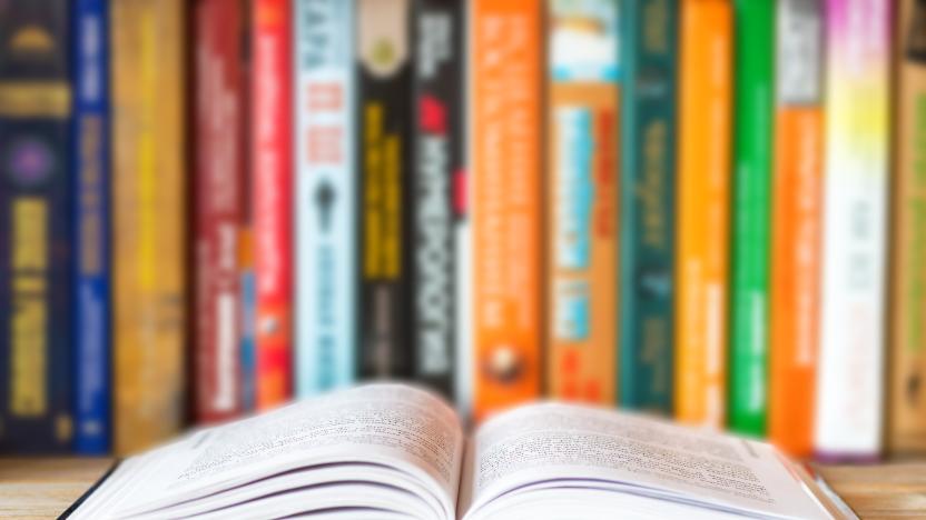 Close-up of opened book on bookshelf on blurred books background. Home library reading books concept. Close up. Selective soft focus. Shallow depth of field. Text copy space.