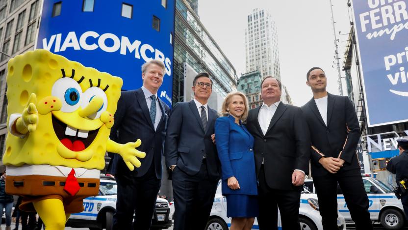 Shari Redstone, chairwoman of ViacomCBS and president of National Amusements, and Robert Bakish, President and CEO of ViacomCBS, pose together with SpongeBob Squarepants, Phil Sims, Stephen Colbert and Trevor Noah, as they celebrate the company's merger at the Nasdaq MarketSite in New York, U.S., December 5, 2019. REUTERS/Brendan McDermid