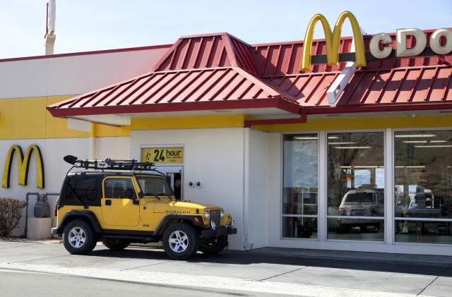 Salt Lake City, USA - February 26, 2013: Mcdonalds Drive thru service is amount one of the popular service in fast food chain restuarants, many stores open 24 hours. A yellow jeep pick up order at the drive thru window.