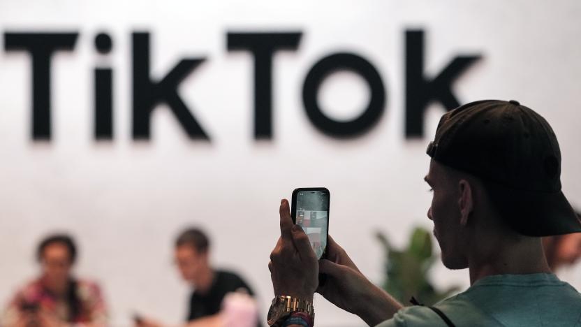 A visitor makes a photo at the TikTok exhibition stands at the Gamescom computer gaming fair in Cologne, Germany, Thursday, Aug. 25, 2022. Around 1,100 exhibitors from 53 countries expect tens of thousands gaming enthusiast daily for the first time since the COVID-19 pandemic at the world's largest gaming event. (AP Photo/Martin Meissner)