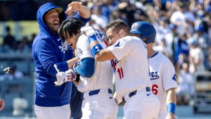 Getty Images - LOS ANGELES, CA - MAY19, 2024: Los Angeles Dodgers designated hitter rShohei Ohtani (17) is swarmed by teammates after hitting his first walk-off hit as a Dodger to beat the Cincinnati Reds 3-2 in 10 innings at Dodger Stadium on May 19, 2024 in Los Angeles, California.(Gina Ferazzi / Los Angeles Times via Getty Images)