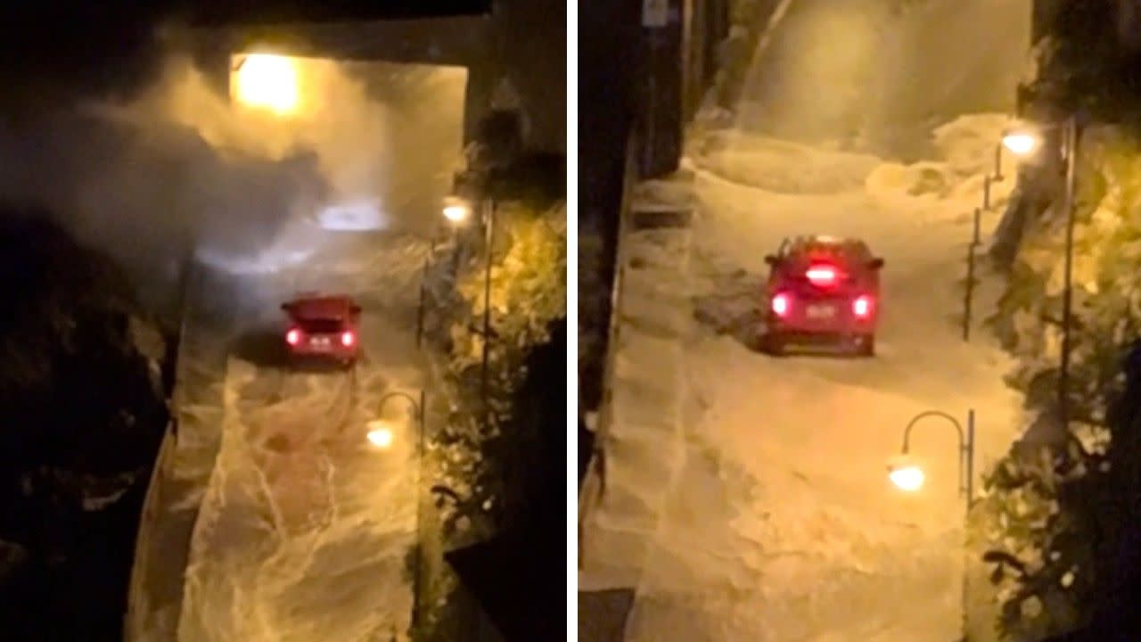 Driver tries to plow through giant waves flooding road in Italy