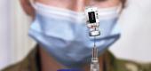 Person prepares a vaccine vial. (Getty Images)