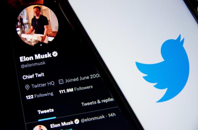 In this photo illustration a Twitter logo seen displayed on a smartphone screen with Elon Musk Twitter in the background in Athens, Greece on October 30, 2022. Elon Musk begins his Twitter ownership with firings. (Photo by Nikolas Kokovlis/NurPhoto via Getty Images)