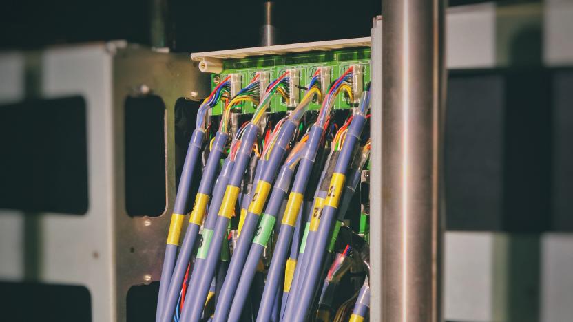 Blue broadband internet cables plugged into a router.