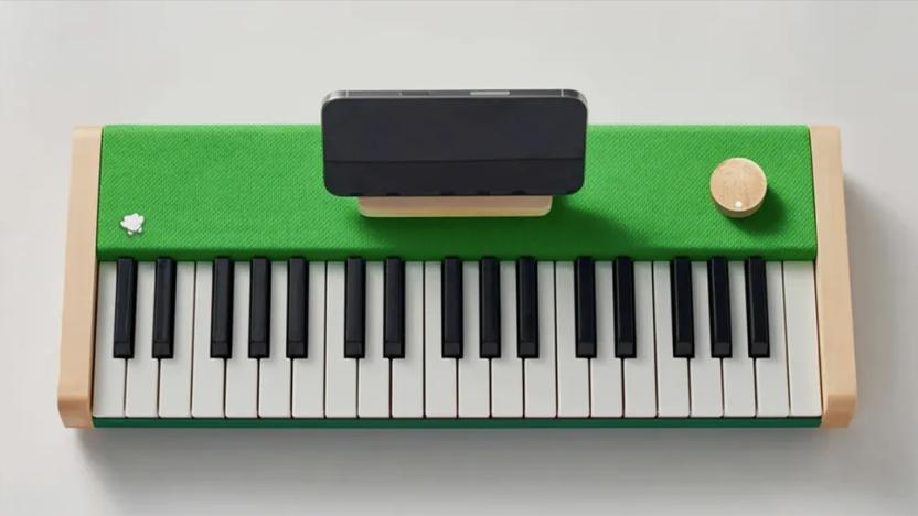 A digital piano with a phone attached.