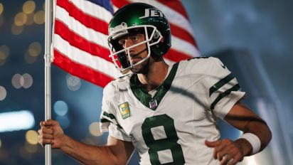 Getty Images - EAST RUTHERFORD, NEW JERSEY - SEPTEMBER 11: Aaron Rodgers #8 of the New York Jets runs onto the field with an American flag during player introductions prior to an NFL football game against the Buffalo Bills at MetLife Stadium on September 11, 2023 in East Rutherford, New Jersey. (Photo by Ryan Kang/Getty Images)