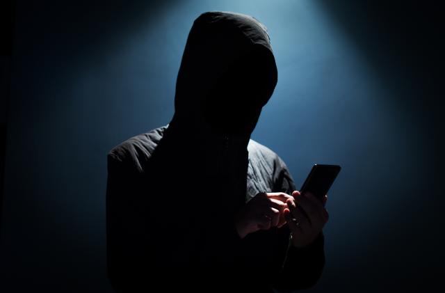 Hacker holding phone