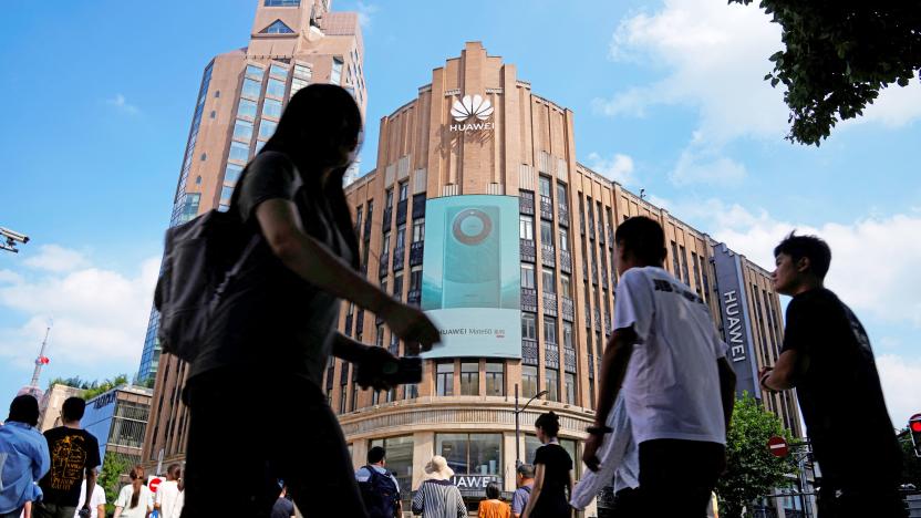 Pedestrians walk past an advertisement for Huawei's Mate 60 series smartphones outside a Huawei store in Shanghai, China September 8, 2023. 