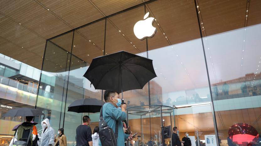 People wearing face masks are pictured at an Apple Store on the day the new Apple iPhone 13 series goes on sale, in Beijing, China, September 24, 2021. REUTERS/Carlos Garcia Rawlins