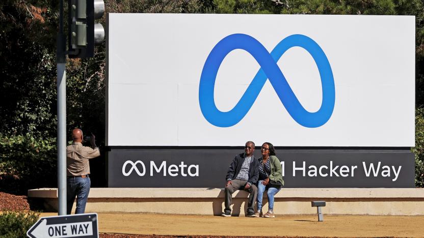 People pose in front of a sign of Meta, the new name for the company formerly known as Facebook, at its headquarters in Menlo Park, California, U.S. October 28, 2021. REUTERS/Carlos Barria