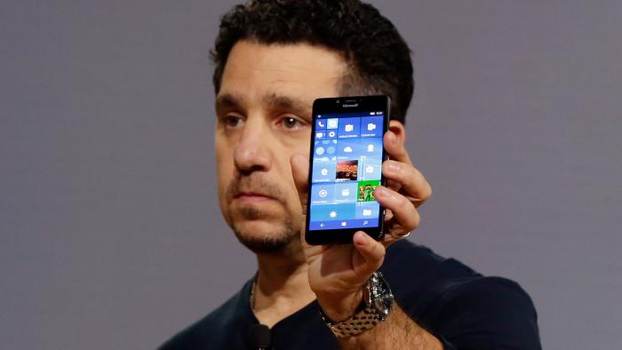 Microsoft vice president for Surface Computing Panos Panay shows a new Lumia 950 phone during a presentation, in New York, Tuesday, Oct. 6, 2015. The device will work with an optional dock. Users can attach a regular monitor, keyboard and mouse and work with apps on the phone just like you would on a Windows 10 desktop. (AP Photo/Richard Drew)