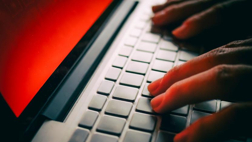 Fingers typing on a laptop keyboard