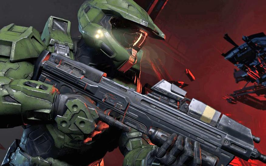 Closeup of Halo Infinite protagonist Master Chief carrying Halo's iconic Assualt Rifle.