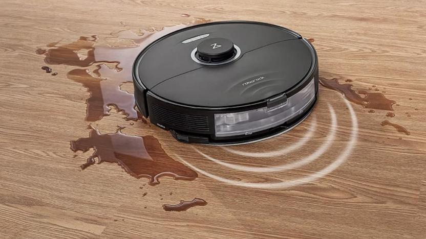 A robot vacuum and mop cleaning up some liquid on a floor.