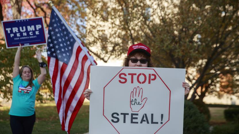 INDIANAPOLIS, INDIANA, UNITED STATES - 2020/11/07: A woman holds a placard saying Stop the Steal as protesters gather near the Indiana State house for a #StoptheSteal rally and to protest Joe Bidens election victory over Donald J. Trump. The election was called in favor of Biden shortly before the rally began. 
The protesters are demanding vote recounts. Similar rallies were held across the United States. (Photo by Jeremy Hogan/SOPA Images/LightRocket via Getty Images)