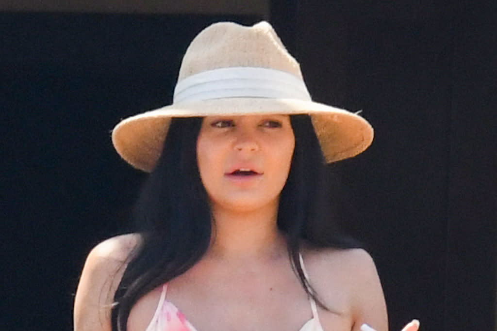 Kylie Jenner Vacations in a Neon Orange Bikini and Cut Out Tangerine Dress