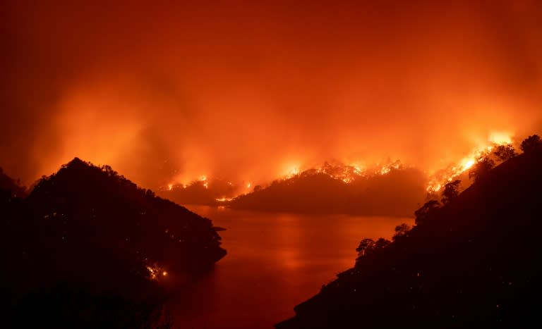 Flames surround Lake Berryessa during the LNU Lightning Complex fire in Napa, California on August 19, 2020