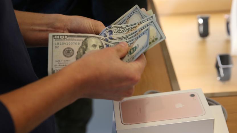 A customer buys the new iPhone 7 smartphone inside an Apple Inc. store in Los Angeles, California, U.S., September 16, 2016. REUTERS/Lucy Nicholson