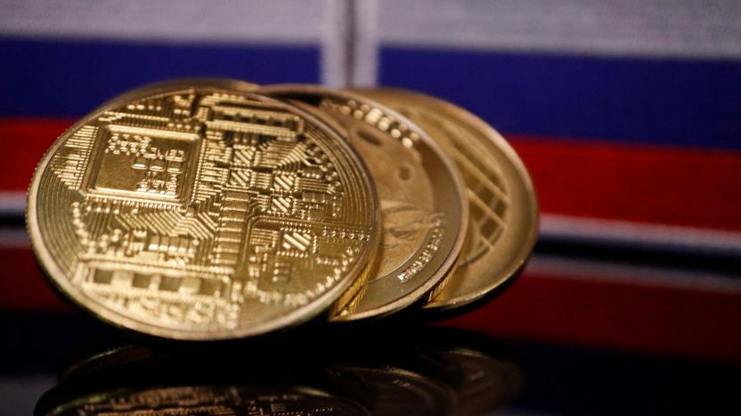 Representations of cryptocurrencies are displayed in front of Russian flags in this picture illustration taken March 4, 2022. REUTERS/Florence Lo/Illustration