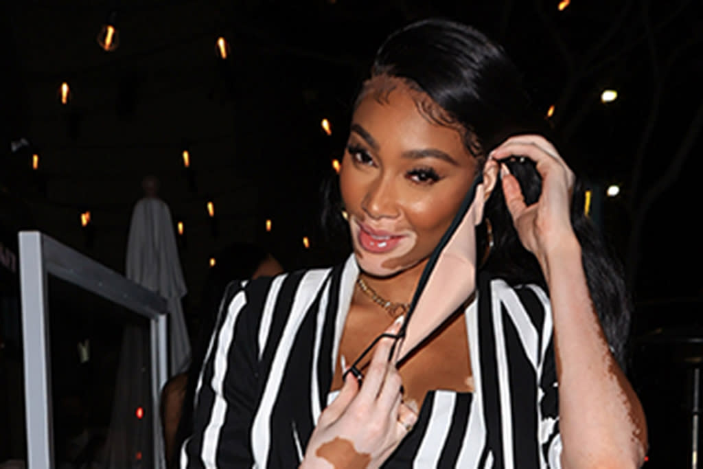 Winnie Harlow Goes Referee Chic In A Striped Coat Mini Skirt Trending Knee High Boots