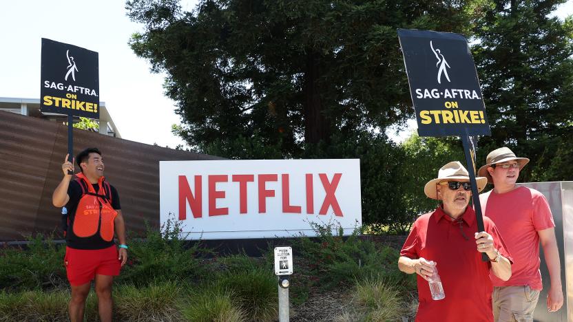 LOS GATOS, CALIFORNIA - JULY 20: Members of SAG-AFTRA hold signs as they picket in front of Netflix headquarters on July 20, 2023 in Los Gatos, California. Hollywood productions have stopped across the country as both writers and actors went on strike after their contracts expired with the Alliance of Motion Picture and Television Producers (AMPTP). This is the first time since 1960 that both unions have gone on strike at the same time. Both unions are fighting for contracts that prevent an A.I. from replacing them at their jobs as well as better pay when working on shows for streaming services. (Photo by Justin Sullivan/Getty Images)