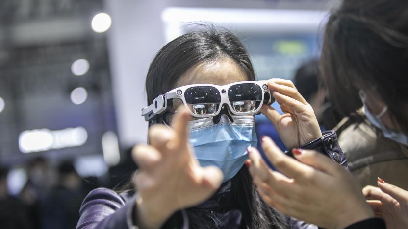 SHANGHAI, CHINA - FEBRUARY 24: A visitor tries out a pair of augmented reality (AR) glasses at the Qualcomm booth during the Mobile World Congress (NWC) Shanghai 2021 at Shanghai New International Expo Center on February 24, 2021 in Shanghai, China. (Photo VCG/VCG via Getty Images)