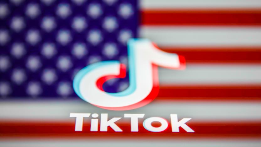 TikTok logo displayed on a phone screen and American flag in the background are seen in this multiple exposure illustration photo taken on August 3, 2020. Microsoft is interested in purchase TikTok platform in the United States. (Photo Illustration by Jakub Porzycki/NurPhoto via Getty Images)