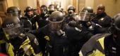 Riot police clear the hallway inside the Capitol on Jan. 6. (Getty Images)