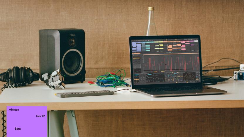 A laptop running Ableton Live 12 alongside a portable synth and a desktop monitor speaker.