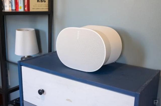 Photo of a white speaker on top of a blue cabinet.