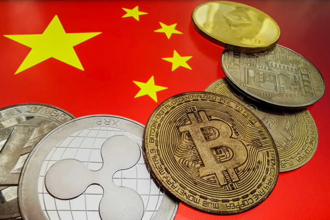 Representation of cryptocurrencies and Chinese flag are seen in this illustration photo taken in Krakow, Poland on September 27, 2021. (Photo by Jakub Porzycki/NurPhoto via Getty Images)