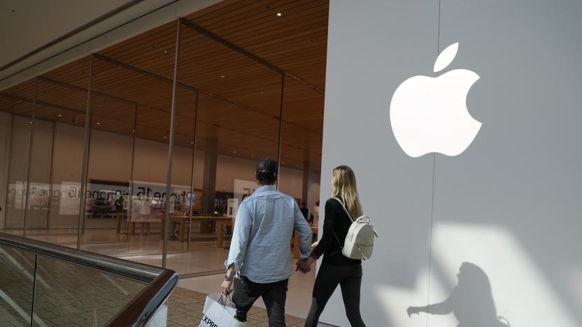 People walk by an Apple store Oct. 20, 2023, in Denver. Apple is now requiring that U.S. law enforcement agencies obtain a court order for information on its customers' push notifications â the alerts iPhone apps send users that can reveal a lot about their online activity. (AP Photo/Brittany Peterson, File)