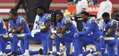 Los Angeles Rams players kneel. (AP)