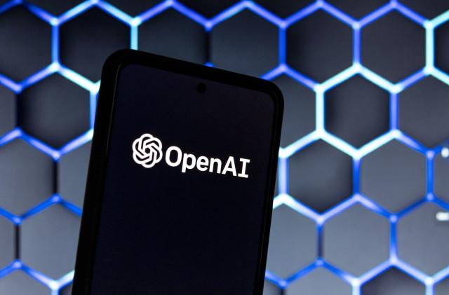 Photo illustration showing ChatGPT and OpenAI research laboratory logo and inscription at a mobile phone smartphone screen with a blurry background. Open AI is an app using artificial intelligence technology. Italy is the first European country to ban and block the robot Chat GPT application and website. ChatGPT is an artificial-intelligence (AI) chatbot developed by OpenAI and launched in November 2022 using reinforcement learning techniques both from machine and human feedback. Amsterdam, the Netherlands on April 1, 2023 (Photo by Nicolas Economou/NurPhoto via Getty Images)