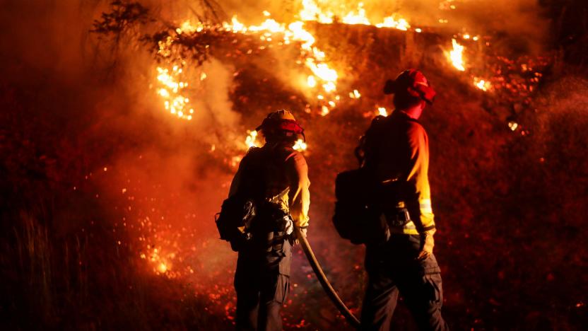 Firefighters extinguish spot fires along Route 89 Dixie Fire in Moccasin, now over 200,000 acres, California, U.S., July 28, 2021.  REUTERS/David Swanson     TPX IMAGES OF THE DAY