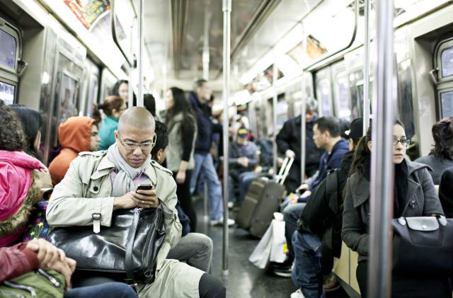 New York, USA - March 15, 2012: People traveling  in a busy subway train in New York city.