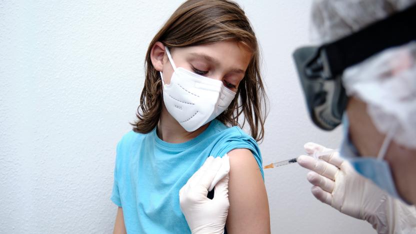 Female doctor giving covid-19 vaccine to a boy