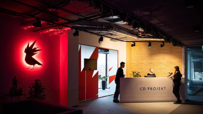 A front desk at CD Projekt Red on the right and the bird logo on the left. 