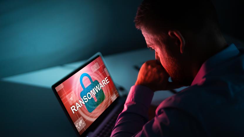 Worried Businessman Looking At Laptop With Ransomware Word On The Screen At The Workplace