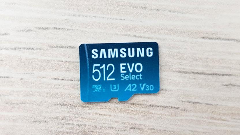 A closeup of a Samsung 512 EVO Select microSD card on a white wood-textured tabletop.