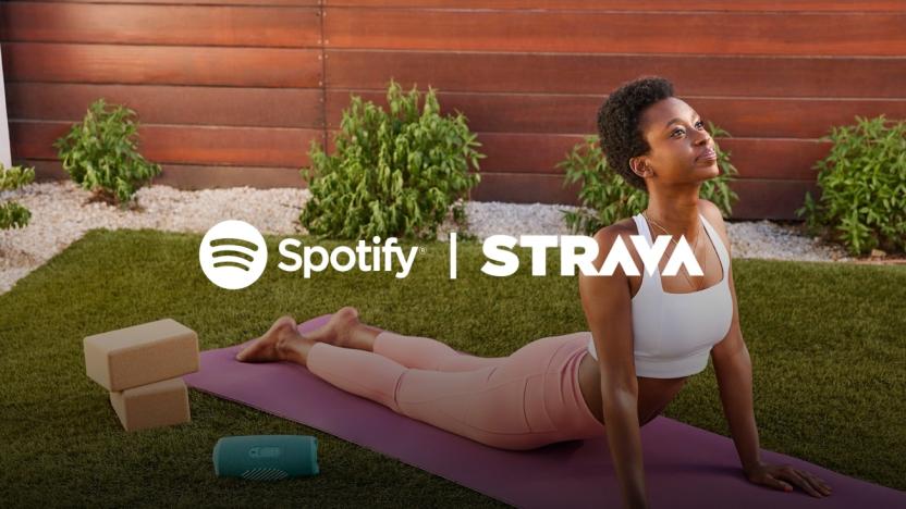 A person does yoga in an outdoor garden with the Spotify and Strava logos laid on top of her. 