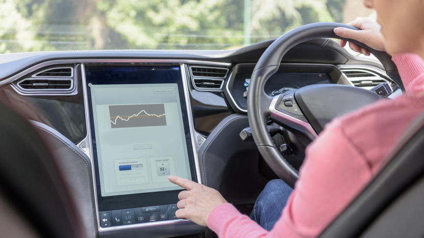 Woman using graphical display in electric car