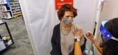 A woman gets a COVID-19 vaccine shot at a CVS pharmacy in Providence, R.I. (Pat Greenhouse/Boston Globe via Getty Images)
