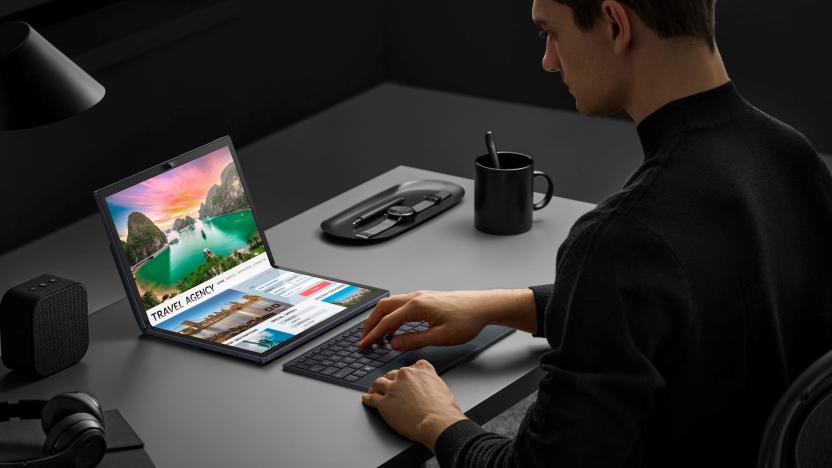 A person has their hands on a Bluetooth keyboard while they look at a ASUS Zenbook 17 Fold OLED.