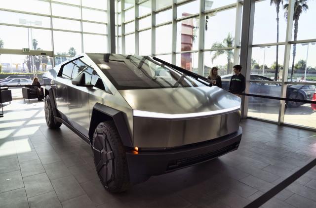 A Tesla Cybertruck is on display at the Tesla showroom in Buena Park, Calif. on Sunday Dec. 3, 2023. With manufacturing kinks still to be worked out, Tesla has delivered the first dozen or so of its futuristic Cybertruck pickups to customers. (AP Photo/Richard Vogel)