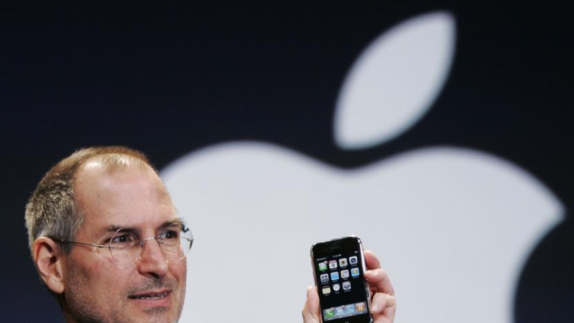 FILE- In this Jan. 9, 2007, file photo, Apple CEO Steve Jobs holds up an iPhone at the MacWorld Conference in San Francisco. Jobs introduced the first iPhone a decade ago. Jobs' "magical product" reshaped culture, shook up industries and made it seem possible to do just about anything with a few taps on a screen while walking around with the equivalent of a computer in our pocket. (AP Photo/Paul Sakuma, File)