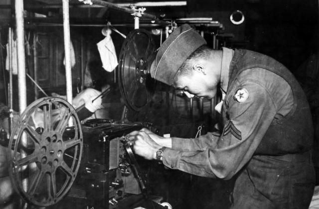 During World War 2, African American soldier Claybourne Miller of the 22nd General Hospital prepares a projector to show a movie to convalescing battle casualties, May 30, 1945. (Photo by Afro American Newspapers/Gado/Getty Images)