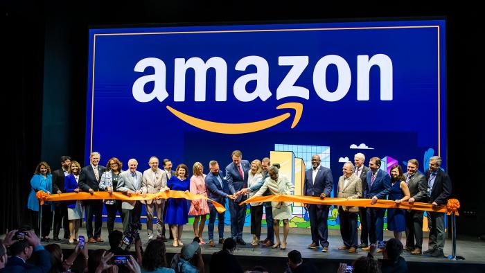 Amazon staffers joyfully cut a ribbon (with Virginia governor Glenn Youngkin) at a ceremony for its second headquarters.