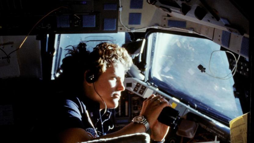 41G-11-027 (14 Oct. 1984) --- Kathryn D. Sullivan, 41-G mission specialist, uses a pair of binoculars to do some magnified viewing through the forward cabin windows of the Earth-orbiting space shuttle Challenger. The 35mm frame was part of the first photographic release from the eight-day 41-G mission on Oct. 14, 1984. Photo credit: NASA